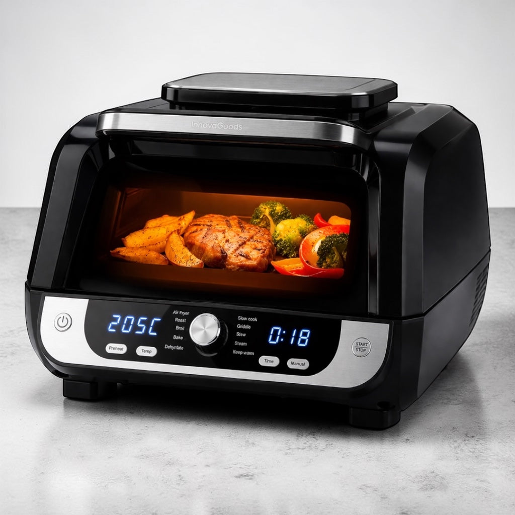 Heißluftfritteuse mit digitalem Display und sichtbarem Garraum mit Fleisch, Kartoffeln und Gemüse bei 205 Grad
