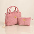 Zweiteiliges Kosmetiktaschen-Set Babyrosa aus Cord mit großer Tasche und kleiner Reißverschlusstasche auf hellem Spiegelboden