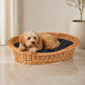 Enovia Hundebett aus Naturweide mit schwarzem Kissen – 75 × 57 cm – Premium Studioaufnahme auf reflektierendem Boden