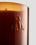 Scented candle in embossed glass — Embossed bee detail | Generated by Modelize