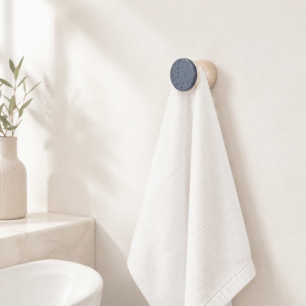 Wandhaken aus Buchenholz & Keramik – Blau Schwarz Sprenkel – im Badezimmer mit weißem Handtuch